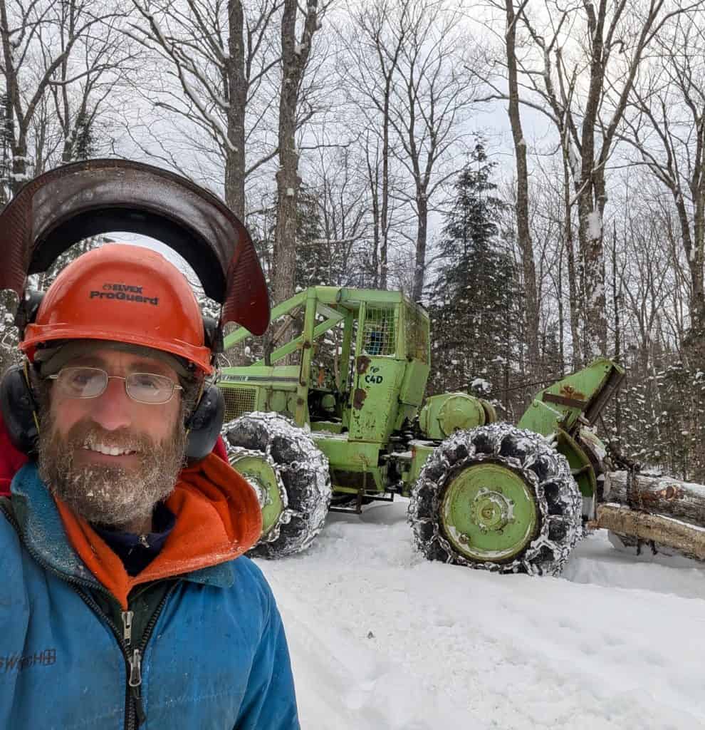 Sam N. standing with his skidder